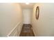 Bright hallway with wood floor and white walls leading to an entry door at 118 S Halifax Ave # 103, Daytona Beach, FL 32118