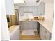 Updated kitchen featuring granite countertops, stainless steel appliances, and gray cabinetry at 118 S Halifax Ave # 103, Daytona Beach, FL 32118