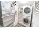 Functional laundry area featuring a stackable washer and dryer at 118 S Halifax Ave # 103, Daytona Beach, FL 32118