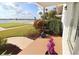 Inviting patio showcasing vibrant flowers and serene views of the lawn and inter-coastal waterway at 118 S Halifax Ave # 103, Daytona Beach, FL 32118