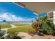 Charming patio with garden views, overlooking a well-maintained lawn and the inter-coastal waterway at 118 S Halifax Ave # 103, Daytona Beach, FL 32118