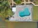 Aerial view of pool with lounge seating and lush landscaping at 118 S Halifax Ave # 103, Daytona Beach, FL 32118