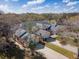 Aerial view of peach-colored residential buildings with well-maintained lawns and driveways set amongst mature trees at 1187 Athlone Way, Ormond Beach, FL 32174