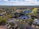 Drone view of a well-situated home near a golf course and surrounded by trees in an established community at 1187 Athlone Way, Ormond Beach, FL 32174