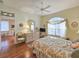 Well-lit bedroom with hardwood floors, large window, and a comfortable sitting area at 1187 Athlone Way, Ormond Beach, FL 32174