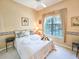 Cozy bedroom with a window offering natural light and a ceiling fan for added comfort at 1187 Athlone Way, Ormond Beach, FL 32174
