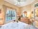 Inviting bedroom featuring a large window with a view of the outdoors and a ceiling fan at 1187 Athlone Way, Ormond Beach, FL 32174