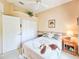 Bedroom featuring a large window, a ceiling fan, and a double closet door for storage at 1187 Athlone Way, Ormond Beach, FL 32174