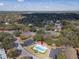 Aerial shot of a community pool surrounded by mature trees and parking lots at 1187 Athlone Way, Ormond Beach, FL 32174