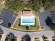 Overhead view of a rectangular community pool with clear water, surrounded by landscaping and parking at 1187 Athlone Way, Ormond Beach, FL 32174