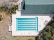 Overhead drone image of a community pool with marked lanes, lounge chairs, and nearby shade trees at 1187 Athlone Way, Ormond Beach, FL 32174