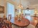 Bright dining room with large windows and access to the sunroom and adjacent rooms at 1187 Athlone Way, Ormond Beach, FL 32174