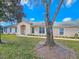 Charming single-story home with a well-maintained lawn and mature tree in the front yard at 1187 Athlone Way, Ormond Beach, FL 32174
