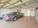 Clean garage with an epoxy floor, a parked car, and lots of storage at 1187 Athlone Way, Ormond Beach, FL 32174