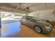 Spacious garage with an epoxy floor featuring a parked car and ample storage at 1187 Athlone Way, Ormond Beach, FL 32174