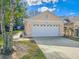 Spacious two-car garage with white door and manicured landscaping at 1187 Athlone Way, Ormond Beach, FL 32174
