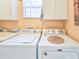 Functional laundry room with laundry machines, sink, and storage at 1187 Athlone Way, Ormond Beach, FL 32174