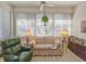 Comfortable sunroom with a cozy sofa, recliner, lots of windows and interior plant at 1187 Athlone Way, Ormond Beach, FL 32174