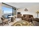 Living room featuring a balcony view, seating and entertainment area at 2301 S Atlantic Ave # 230, Daytona Beach, FL 32118
