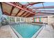 Indoor pool area with stone accents, tile floors, and a wood-beam ceiling at 2301 S Atlantic Ave # 230, Daytona Beach, FL 32118