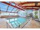 Bright indoor pool area featuring mural, tile floor, glass surround, and natural wood ceiling at 2301 S Atlantic Ave # 230, Daytona Beach, FL 32118