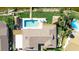 Aerial view showcasing a private pool, tiki huts, and lush waterfront landscaping at 2912 River Point Dr, Daytona Beach, FL 32118