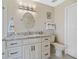 Bright bathroom with white cabinets, granite countertop sink, and modern lighting at 2912 River Point Dr, Daytona Beach, FL 32118