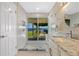 Bright bathroom with standup shower, outdoor access, white cabinets and granite countertop sink at 2912 River Point Dr, Daytona Beach, FL 32118