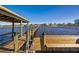 Covered dock on the water with a built-in bench and ladder with a view of the city skyline at 2912 River Point Dr, Daytona Beach, FL 32118