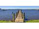 Long wooden dock extending into the waterway and featuring dark wooden posts with rope accents at 2912 River Point Dr, Daytona Beach, FL 32118