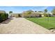 Single story home with a stone facade, large driveway, well-manicured lawn, and attached carport at 2912 River Point Dr, Daytona Beach, FL 32118