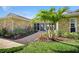 Beautiful landscaped front yard with brick walkway and modern, stone exterior featuring tropical landscaping at 2912 River Point Dr, Daytona Beach, FL 32118