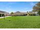 Stunning stone home featuring a manicured lawn and mature landscaping at 2912 River Point Dr, Daytona Beach, FL 32118