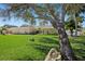 A charming stone home with a lush lawn and mature shade tree at 2912 River Point Dr, Daytona Beach, FL 32118