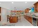 Open kitchen featuring a large island with seating, wood cabinets, and open access to the living area at 2912 River Point Dr, Daytona Beach, FL 32118