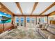 Bright living room featuring wood ceilings, exterior access, and a lovely water view at 2912 River Point Dr, Daytona Beach, FL 32118