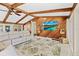 Cozy living room with vaulted wood ceilings, ceiling fan, and mounted television at 2912 River Point Dr, Daytona Beach, FL 32118