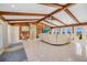 Bright living room featuring vaulted ceilings, ceiling fan, access to the outdoors, and wood paneled accent walls at 2912 River Point Dr, Daytona Beach, FL 32118