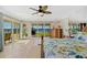 Bright main bedroom featuring outdoor access, ceiling fan, and a scenic water view at 2912 River Point Dr, Daytona Beach, FL 32118