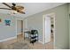 This bright office space features a ceiling fan, tiled floors and a door to the bedroom at 2912 River Point Dr, Daytona Beach, FL 32118