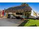 Relaxing tiki hut with comfortable seating and lush landscaping at 2912 River Point Dr, Daytona Beach, FL 32118