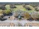 Aerial view of the clubhouse and golf course surrounded by lush landscaping and a parking lot at 3257 Bailey Ann Dr, Ormond Beach, FL 32174