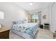 Comfortable bedroom with a patterned bedspread, bright window, and modern decor, creating a cozy retreat at 3257 Bailey Ann Dr, Ormond Beach, FL 32174