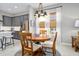 A dining area features modern lighting and natural light, complemented by the kitchen in the background at 3257 Bailey Ann Dr, Ormond Beach, FL 32174
