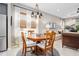 A cozy dining area includes a wooden table and seating beneath a modern pendant light fixture at 3257 Bailey Ann Dr, Ormond Beach, FL 32174