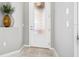 Welcoming entryway features a glass-paneled front door, neutral decor, and a decorative vase on a ledge at 3257 Bailey Ann Dr, Ormond Beach, FL 32174
