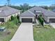 Charming single-Gathering home featuring a well-manicured front yard, a paved driveway, and an attached two-car garage at 3257 Bailey Ann Dr, Ormond Beach, FL 32174