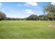 Wide view of the green golf course with the players at 3257 Bailey Ann Dr, Ormond Beach, FL 32174