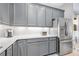 The kitchen features a stainless steel refrigerator, ample counter space, and gray cabinets at 3257 Bailey Ann Dr, Ormond Beach, FL 32174