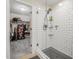 Walk-in shower with white subway tile and a glimpse into a well-organized walk-in closet at 348 Southern Winds Blvd, Deland, FL 32720